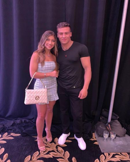 Giu Giudice in white with Frankie Catania in a black t-shirt pose for a picture.